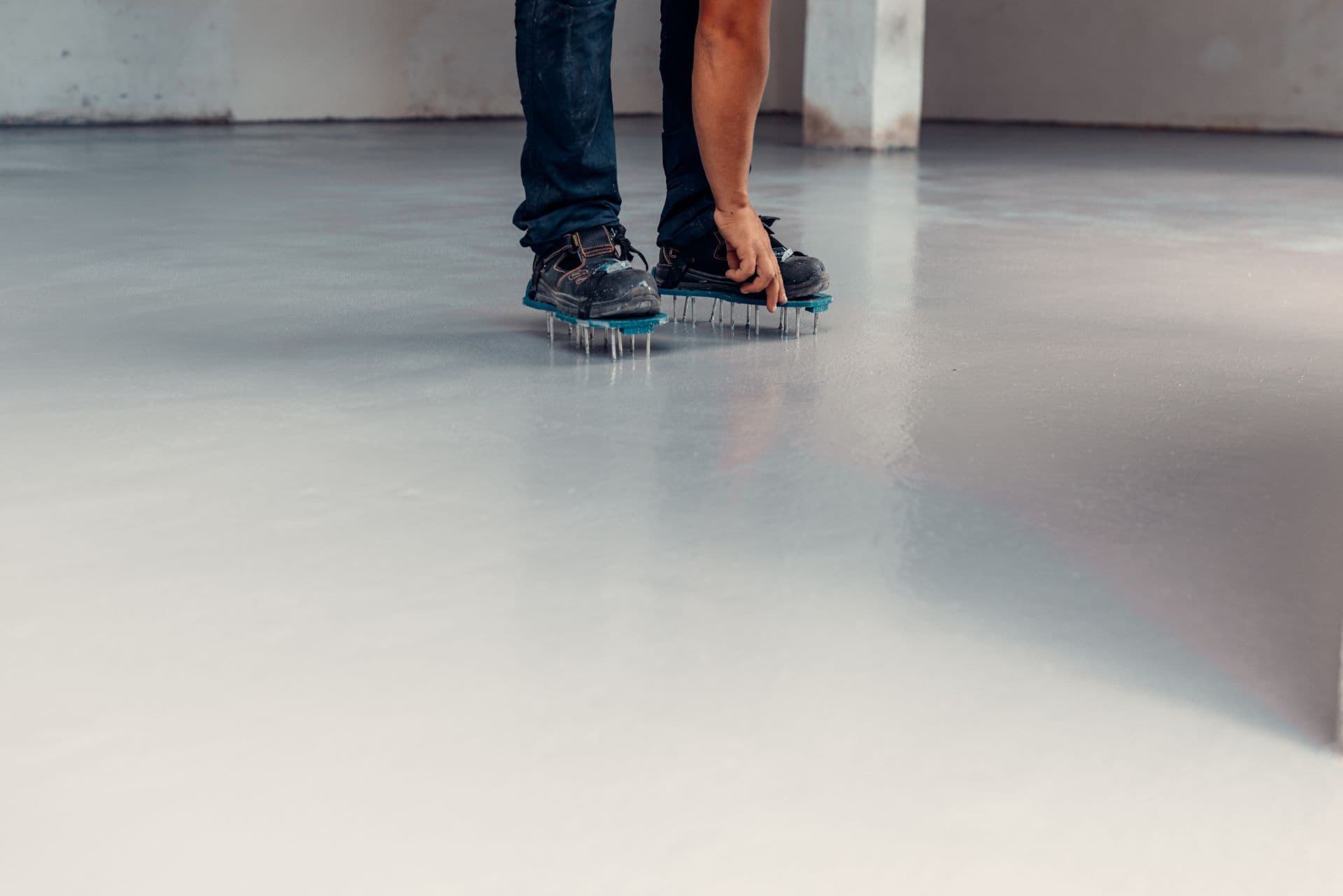 Applicator finishing a freshly placed self-leveling resinous floor